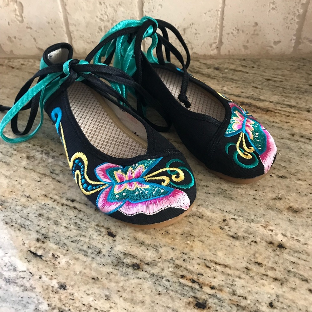 Pair of embroidered tie shoes